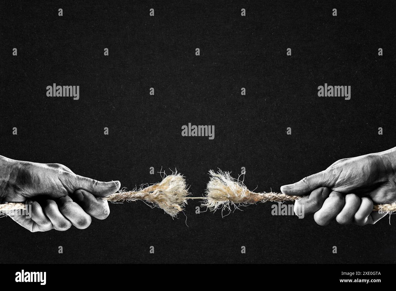 Hand in Black and White Pulling Frayed Rope to Opposite Sides at ...