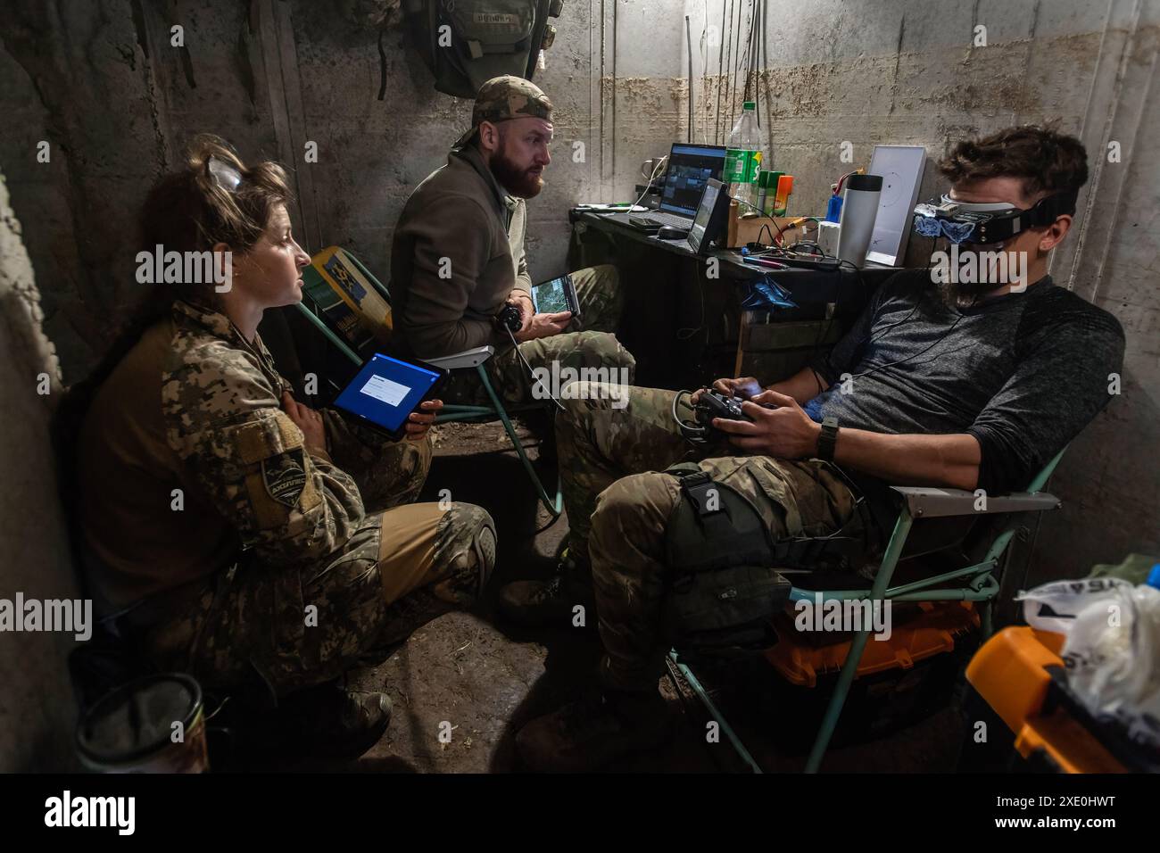 An FPV drone unit from the 92nd Brigade, known as "Achilles", operates inside a bunker about 10 kilometers from the Russian border in Kharkiv Oblast, Ukraine. First Person View (FPV) drones have changed the nature of warfare in Ukraine, with both Ukrainian and Russian forces coming to rely on these drones, which are armed with explosives and remotely controlled by a pilot wearing a headset. Stock Photo