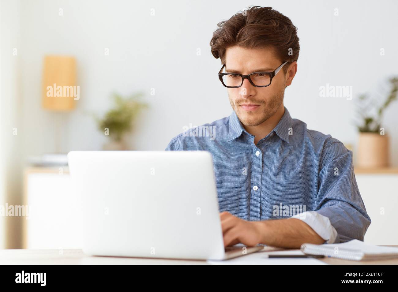 Man Working on Laptop in Office Stock Photo