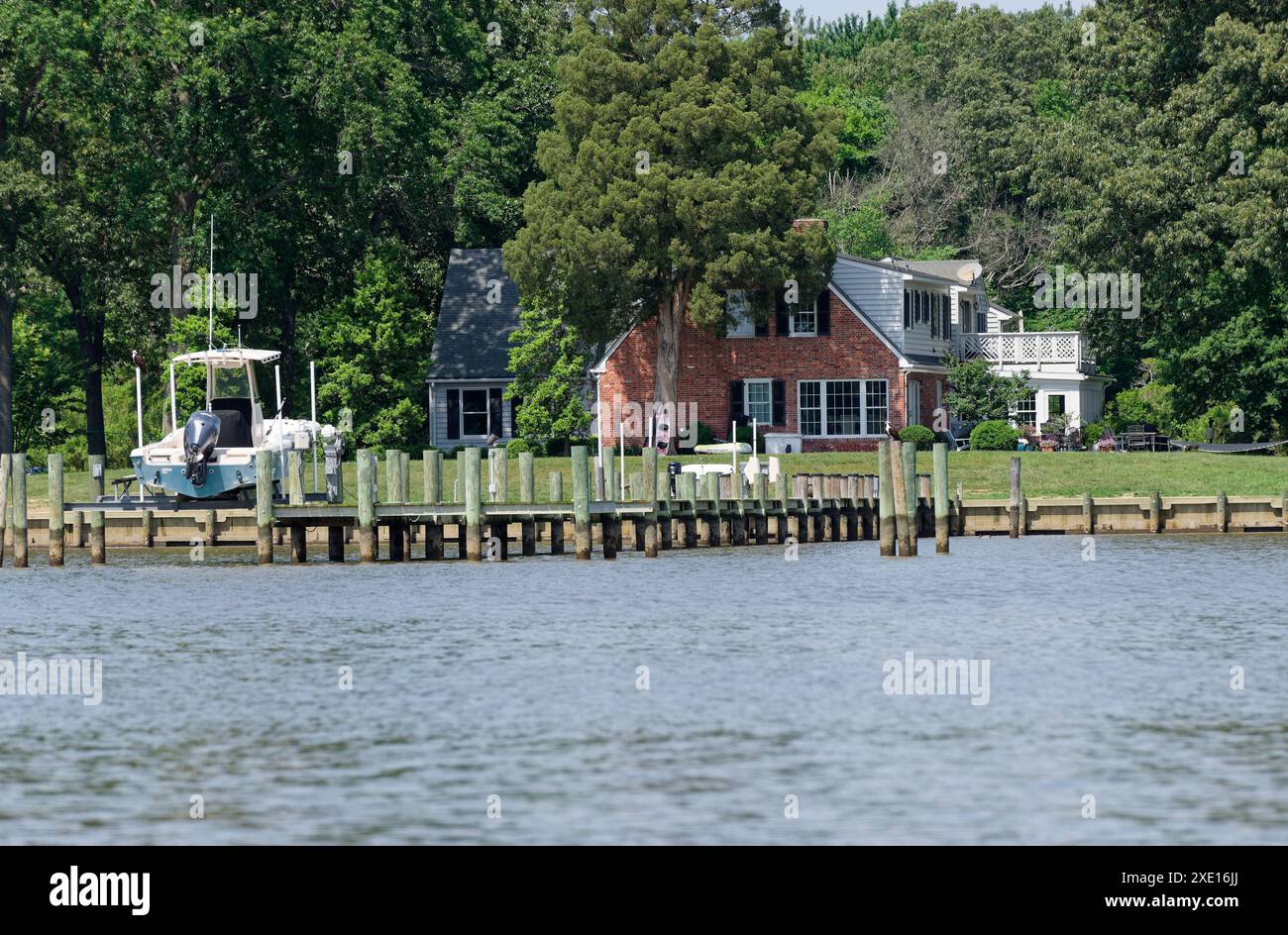 USA riverside home with jetty and boat. Stock Photo