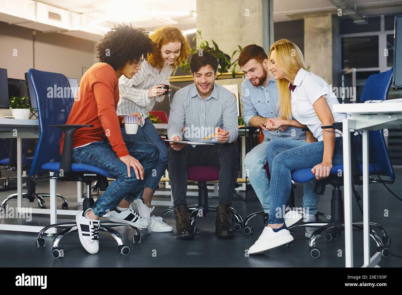 Young creative team discussing new project in coworking space Stock Photo
