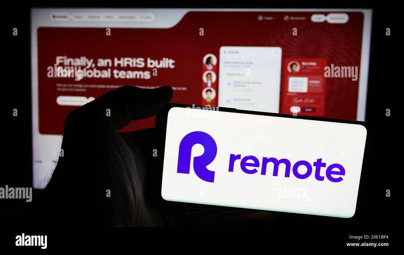 Person holding mobile phone with logo of american hr software company