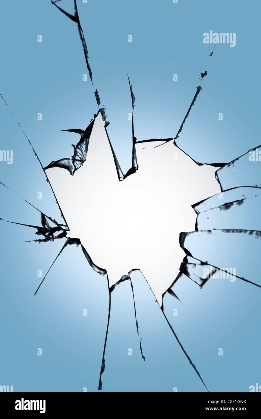 Pieces of broken glass with a hole in the center on a blue background.  Texture of cracks on the window. Destruction effect for d Stock Photo -  Alamy, image size:866x1390