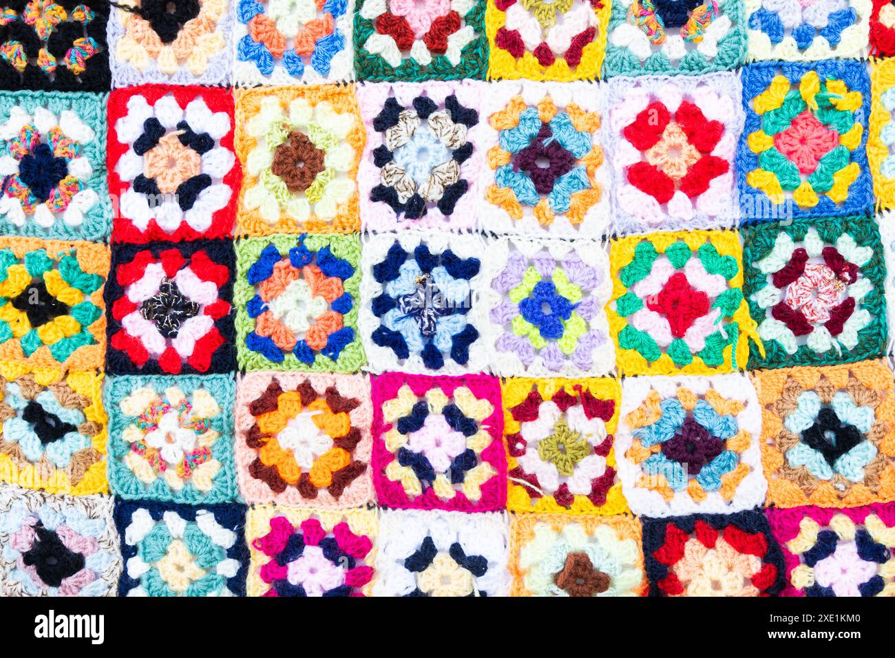 Multi colored blanket in wool, square geometric background, retro decorative pattern Stock Photo