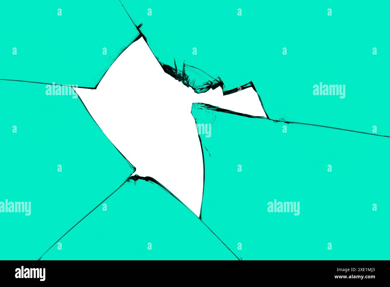 A piece of broken glass with a hole and cracks. Green window with white background in center, destruction effect, texture for de Stock Photo