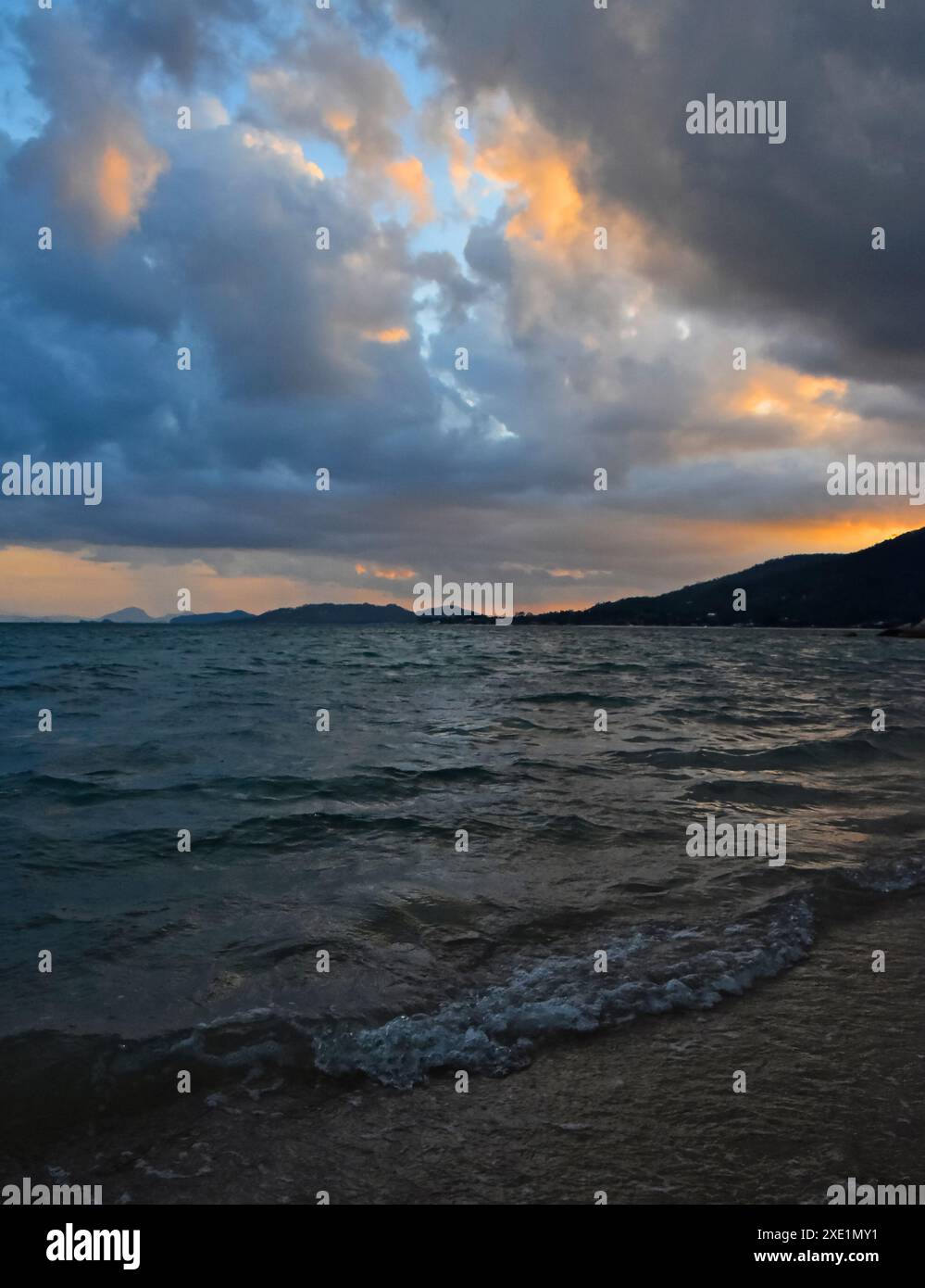 Stormy sunset over sea shore Stock Photo