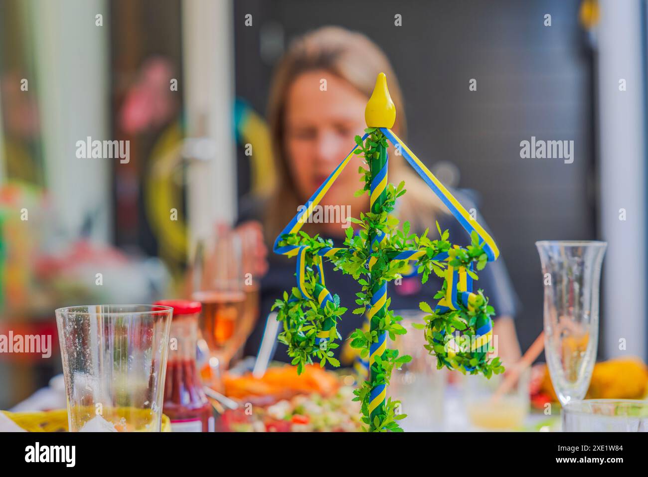Midsummer Ribbons Close-up view of decorated midsummer pole with greenery and yellow-blue ...