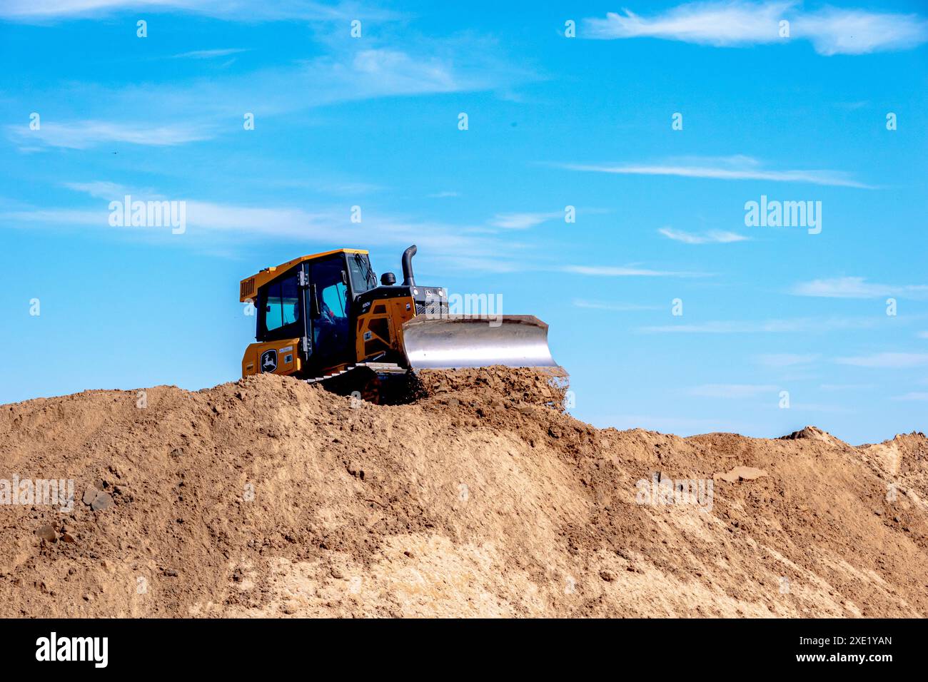 Heavy excavator working on the sand beach restoration Stock Photo - Alamy