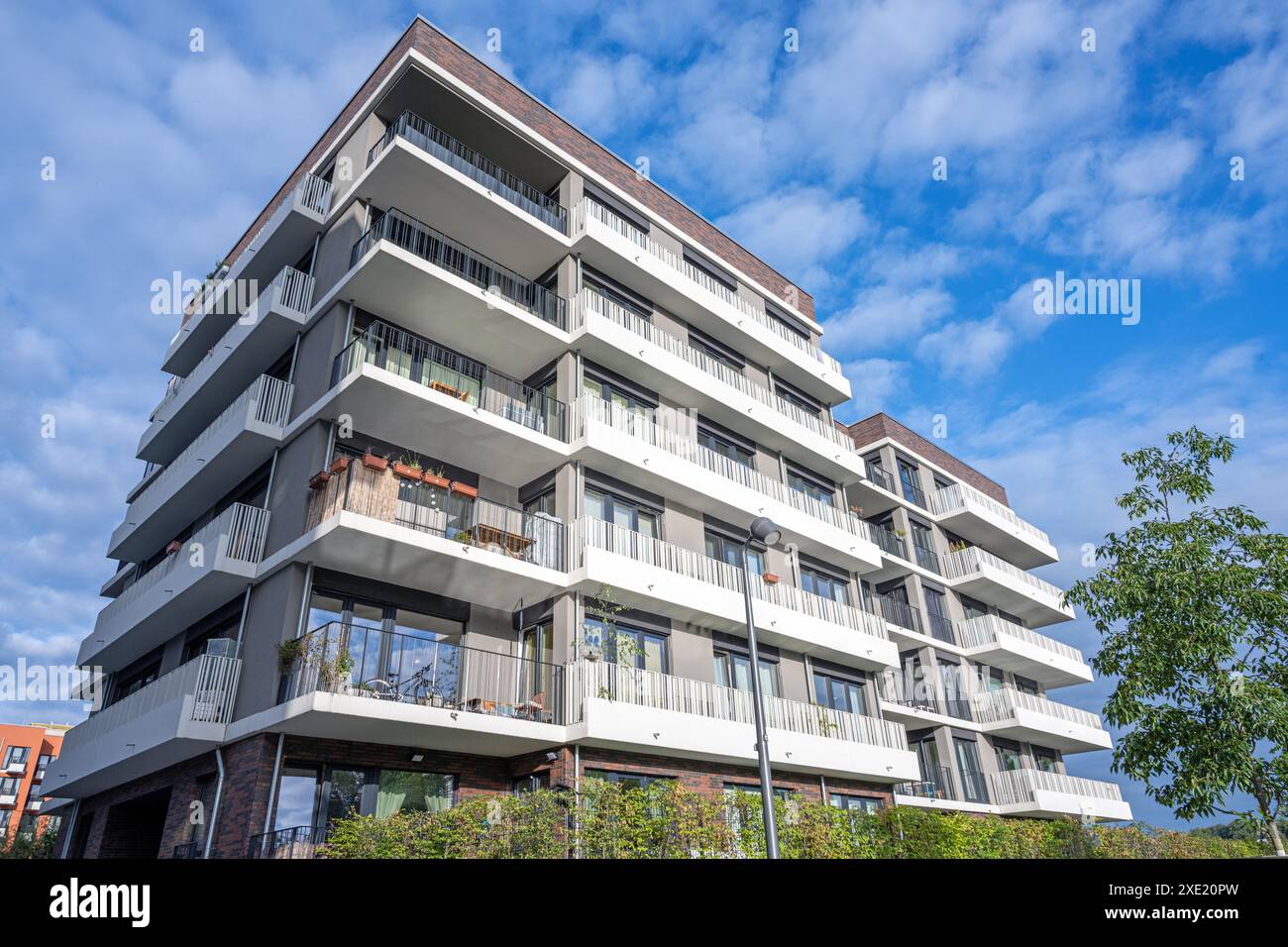 Modern apartment building with sunlit balconies seen in Berlin, Germany ...