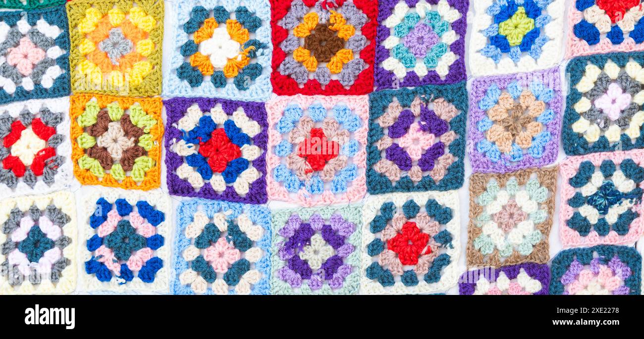 Multi colored blanket in wool, square geometric background, retro decorative pattern Stock Photo