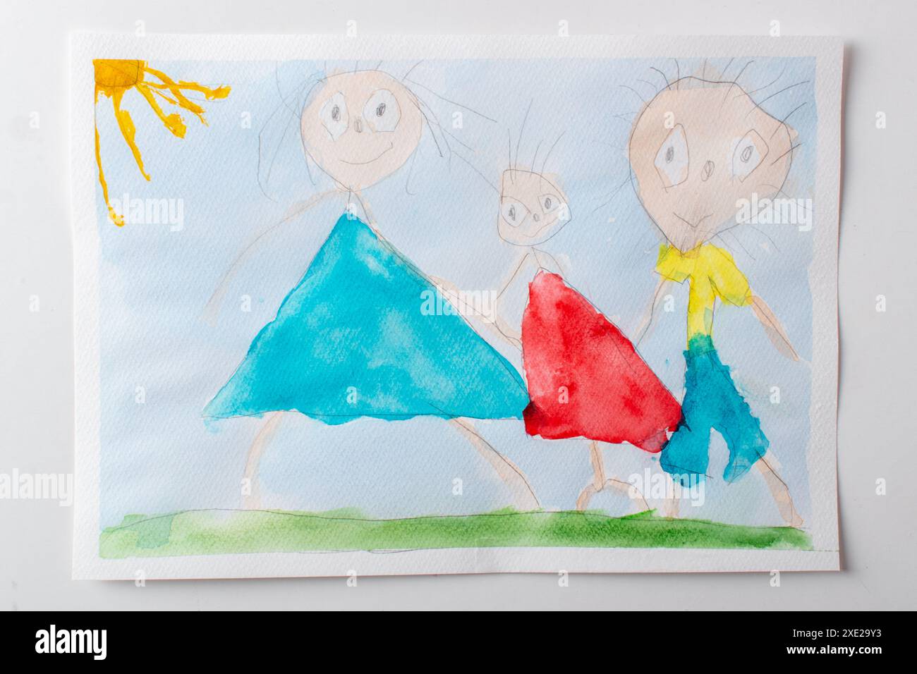 Children's drawing of mom, dad, and child, in watercolor paints. A ...