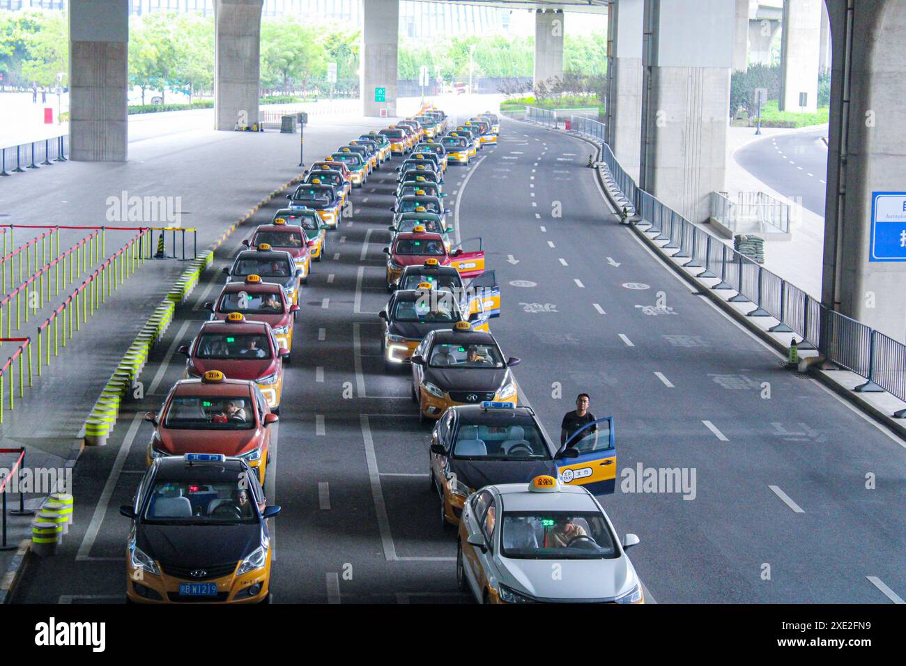 Harbin, China - June 17, 2024: Queue of taxis at the airport. There are ...