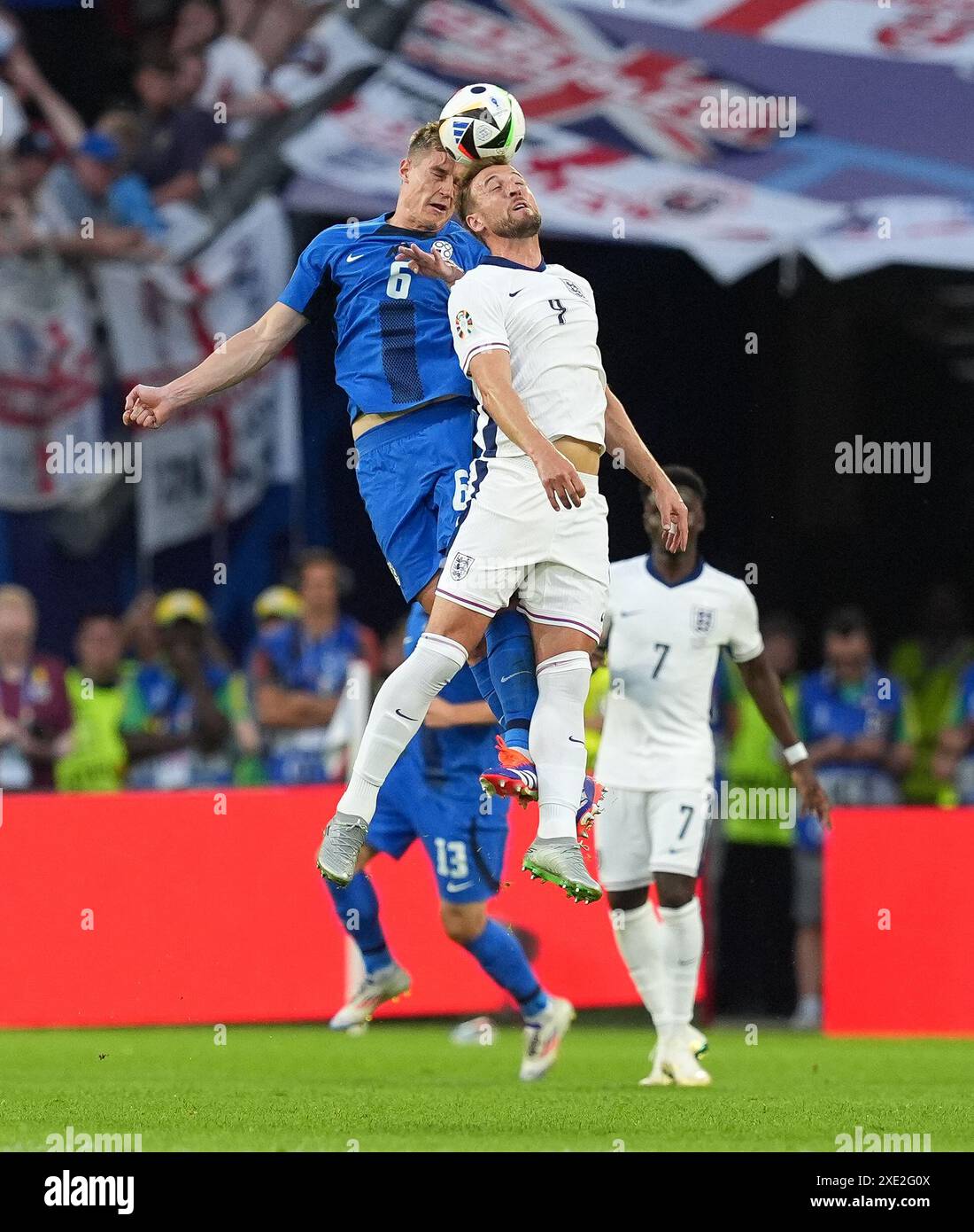 England's Harry Kane (right) and Slovenia's Jaka Bijol battle for a header during the UEFA Euro 2024 Group C match at the Cologne Stadium in Cologne, Germany. Picture date: Tuesday June 25, 2024. Stock Photo
