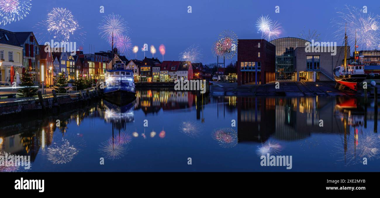 Fireworks, festive lighting and Sylvester romantic atmosphere in Husum at night. Nighttime view of H Stock Photo