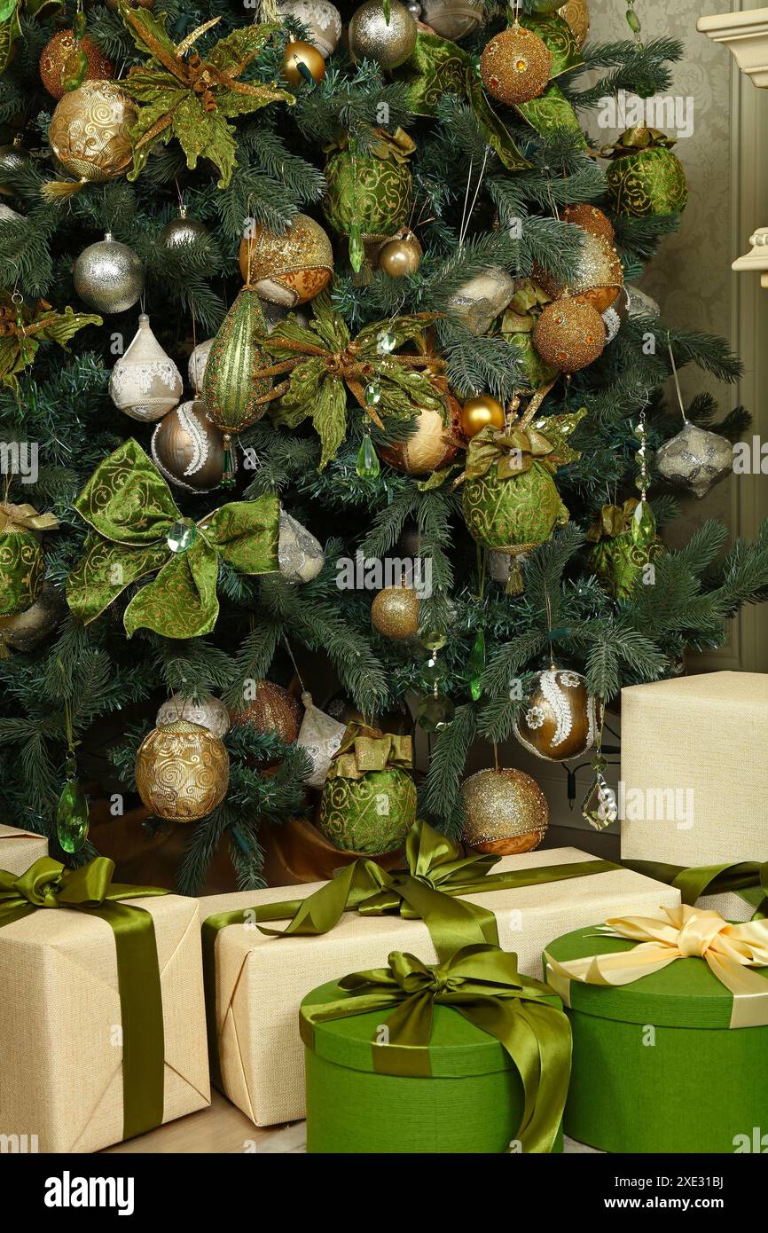 Close up gift boxes under green Christmas tree Stock Photo