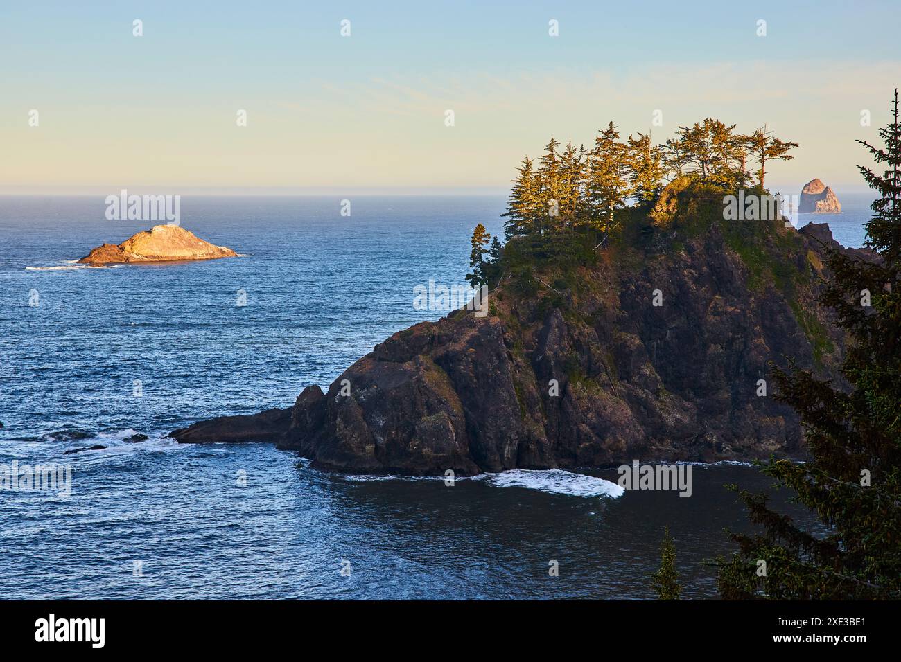 Rugged Coastal Cliffs and Arch Rock at Golden Hour Aerial Perspective Stock Photo