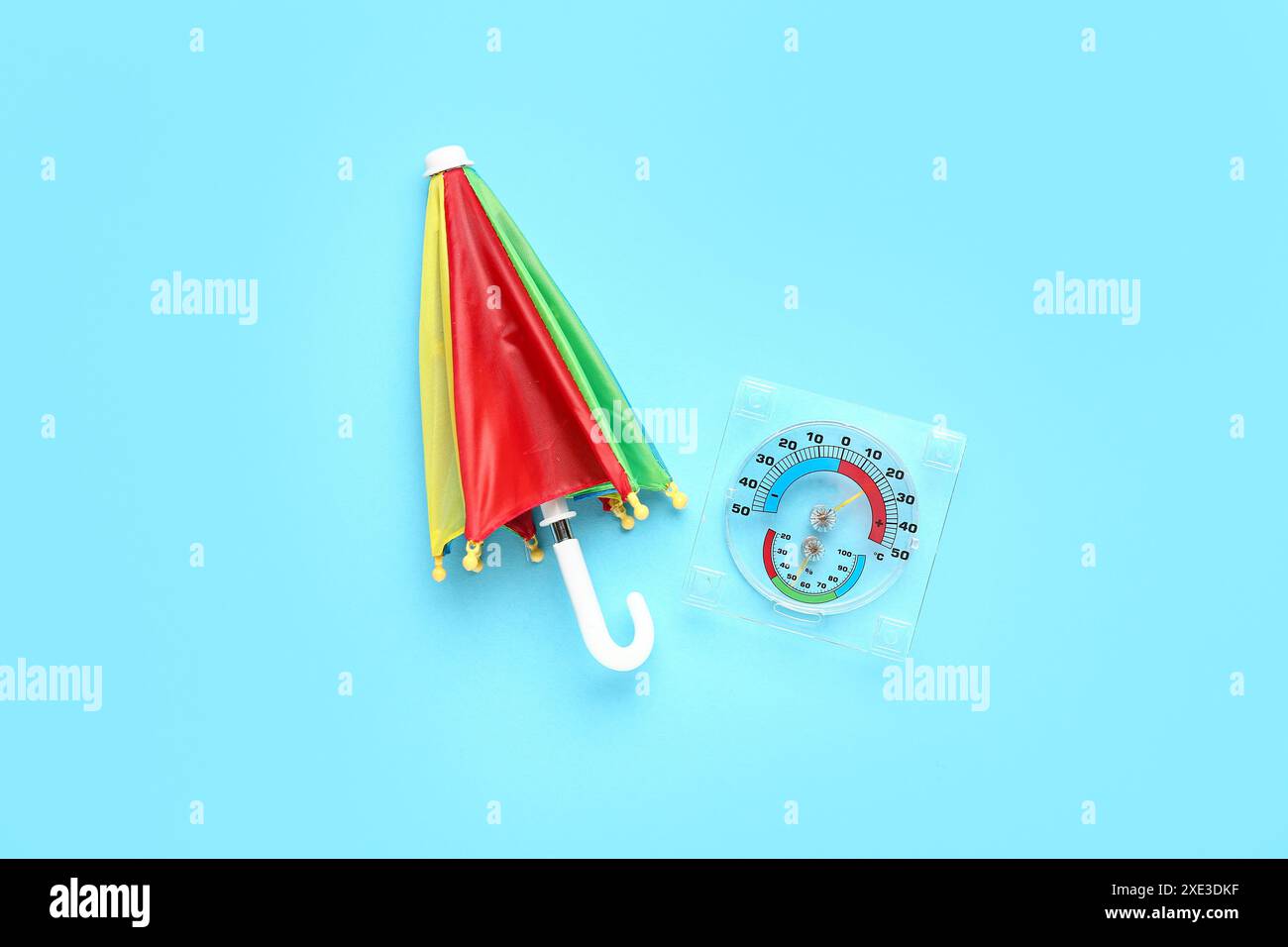 Mini colorful umbrella on blue background Stock Photo