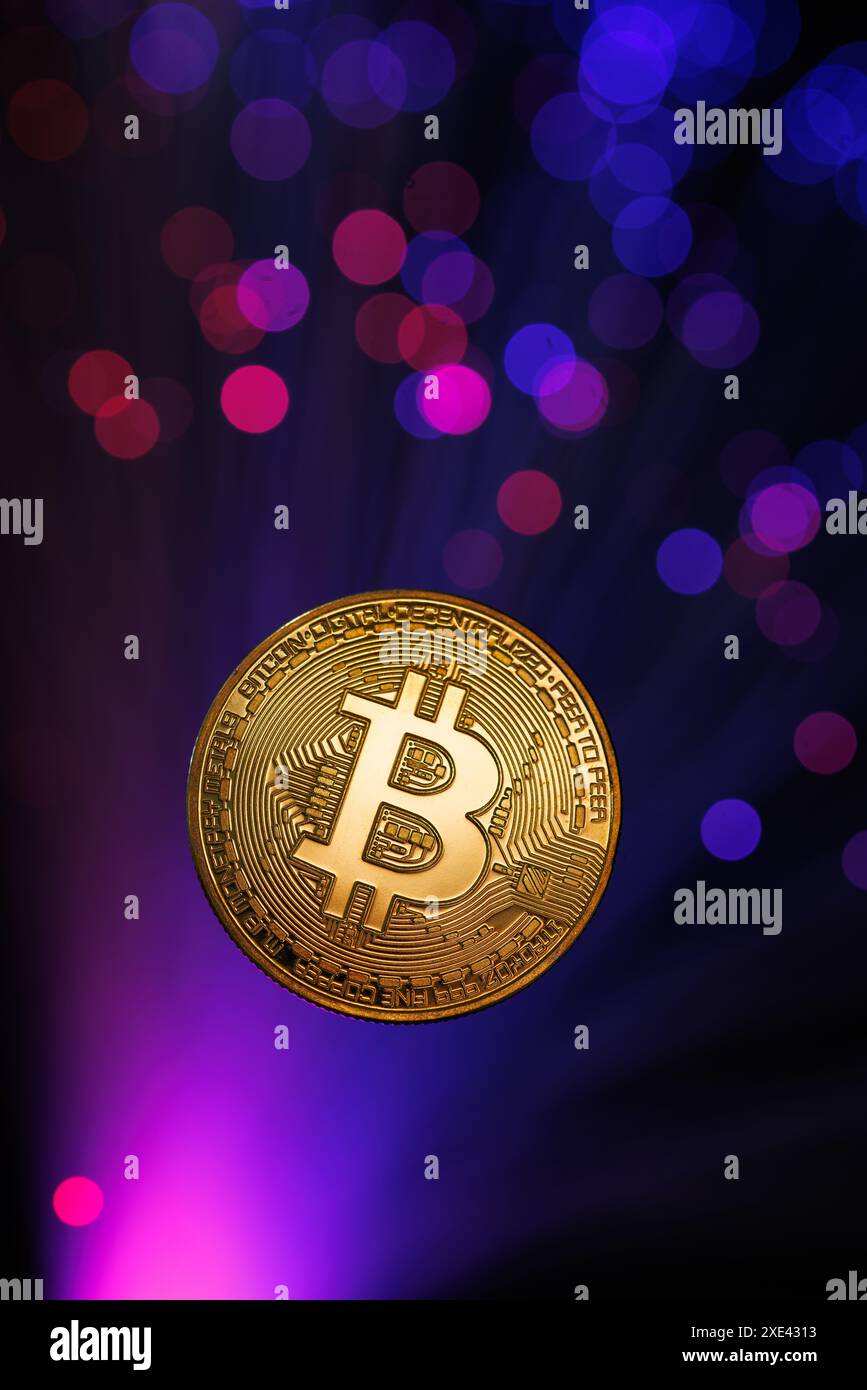 Glowing Bitcoin cryptocurrency against the background of fiber optic cables. Bitcoin digital cryptocurrency consisting of dots and lines, cryptocurren Stock Photo