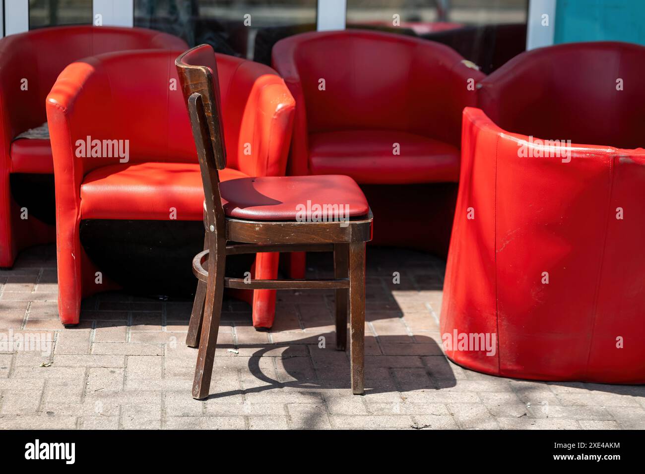 Old modern red seating furniture on a street Stock Photo