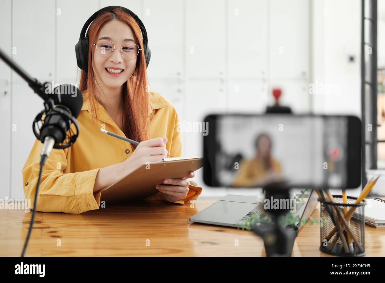 Live Podcast Session with Smiling Female Host. Stock Photo