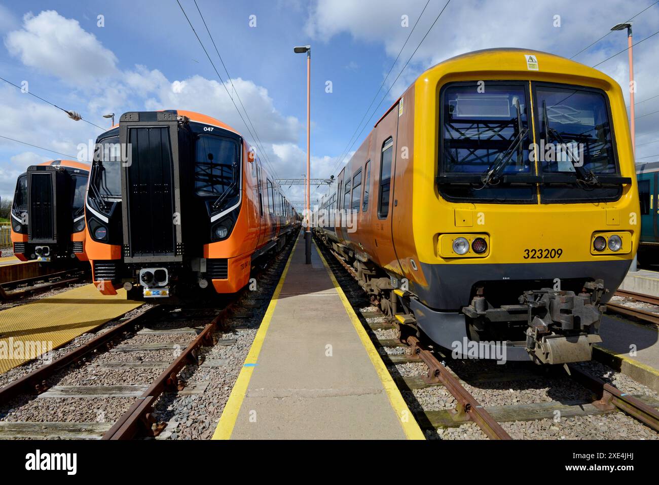 New West Midlands Railway Alstom class 730 electric trains seen in WMR Soho Depot, Birmingham next to older Class 323 EMU trains, April 2024 Stock Photo