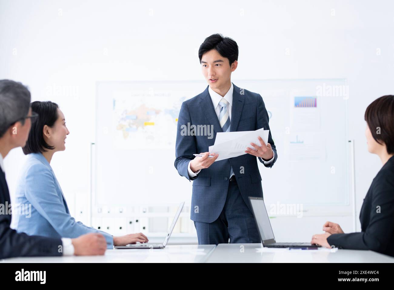 Presenting Presenting documents asian male in hi-res stock photography and images ...