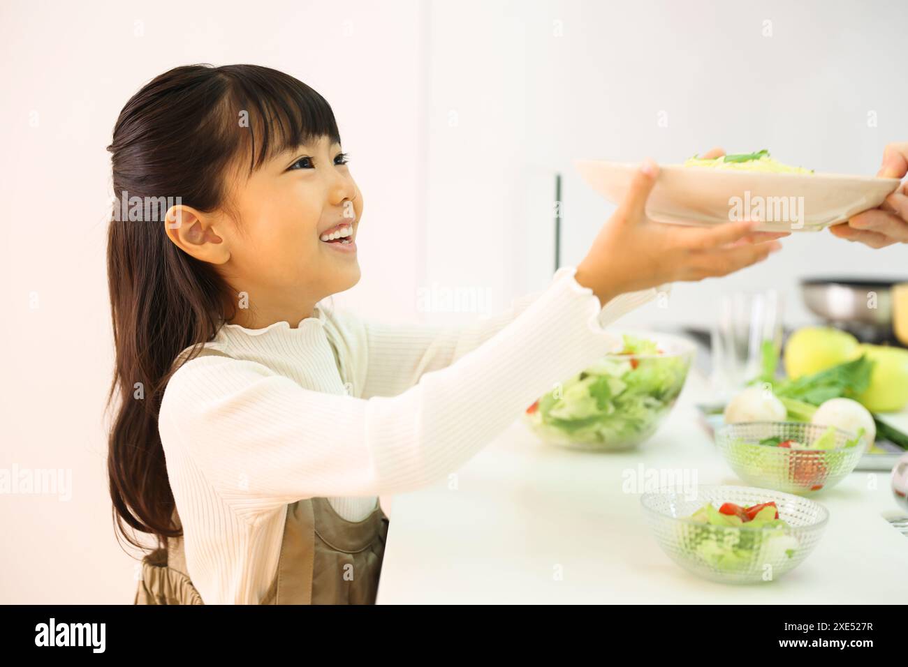 Girl helping to serve food Stock Photo - Alamy