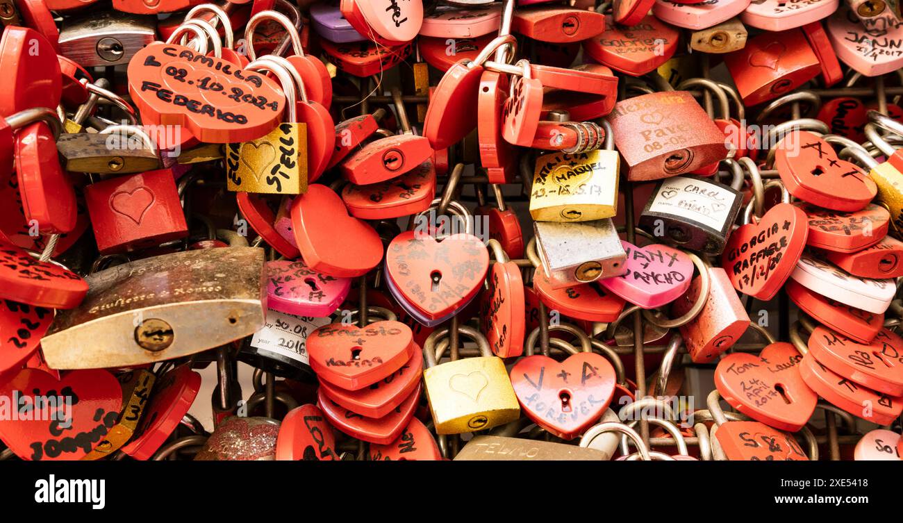 Verona, Italy - June 2022: background of heart-shaped locks on a wall ...