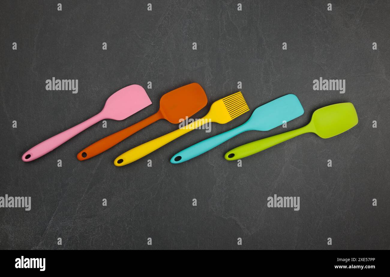 Silicone culinary spatulas and brushes on black Stock Photo