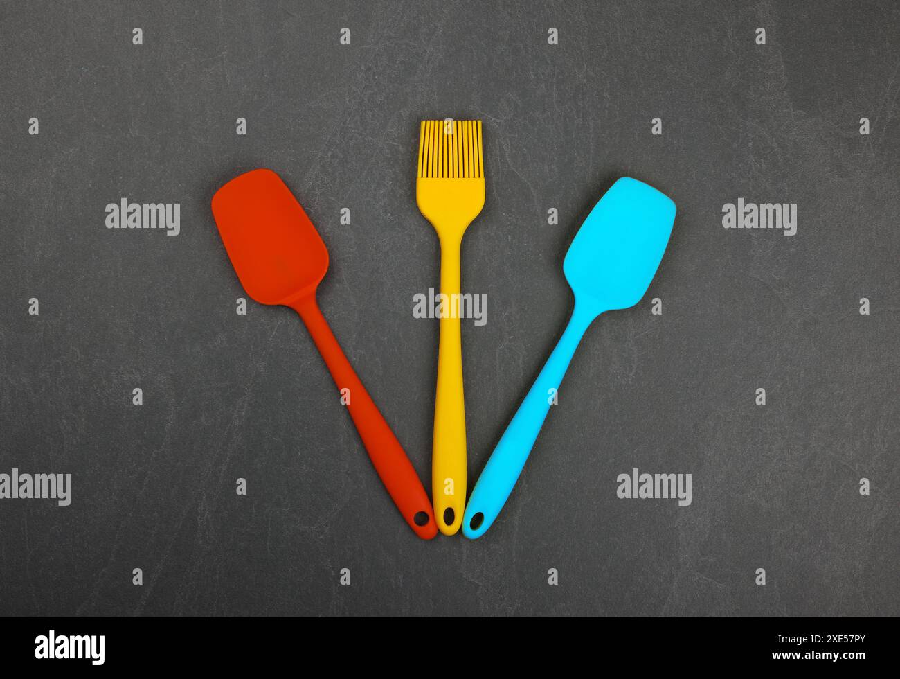 Silicone culinary spatulas and brushes on black Stock Photo