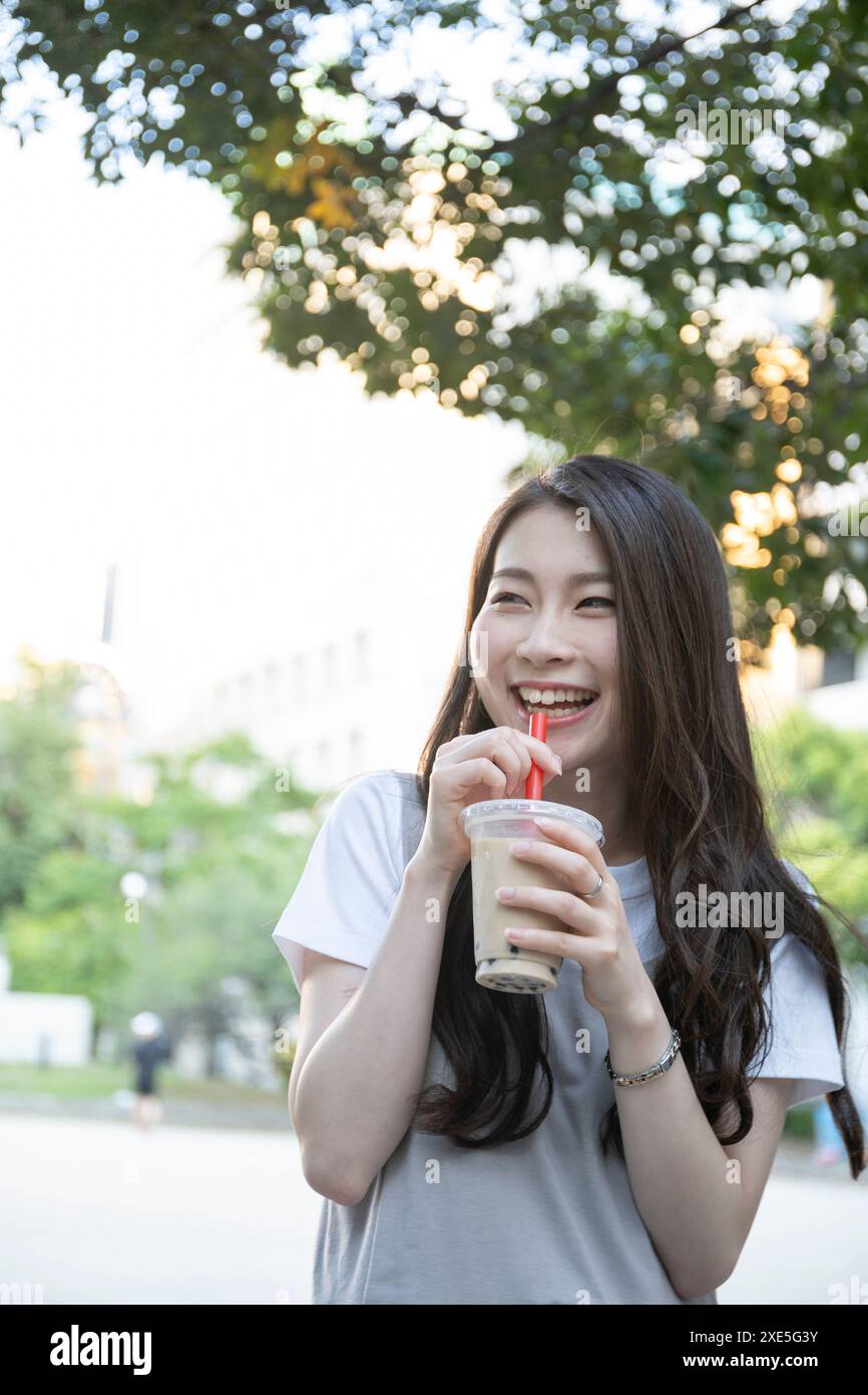 Young woman drinking juice Stock Photo