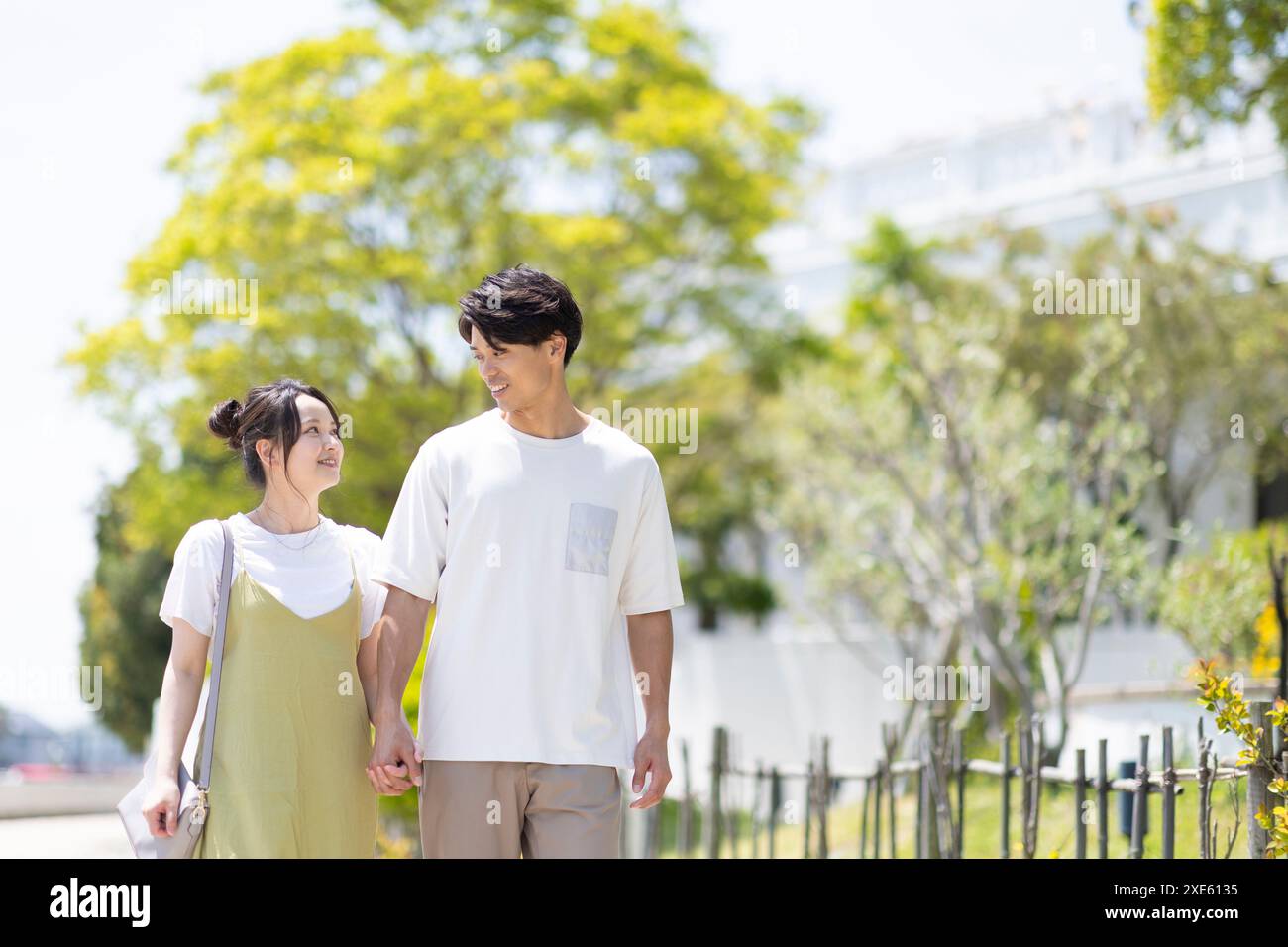 Asian couple walking talking in hi-res stock photography and images - Alamy