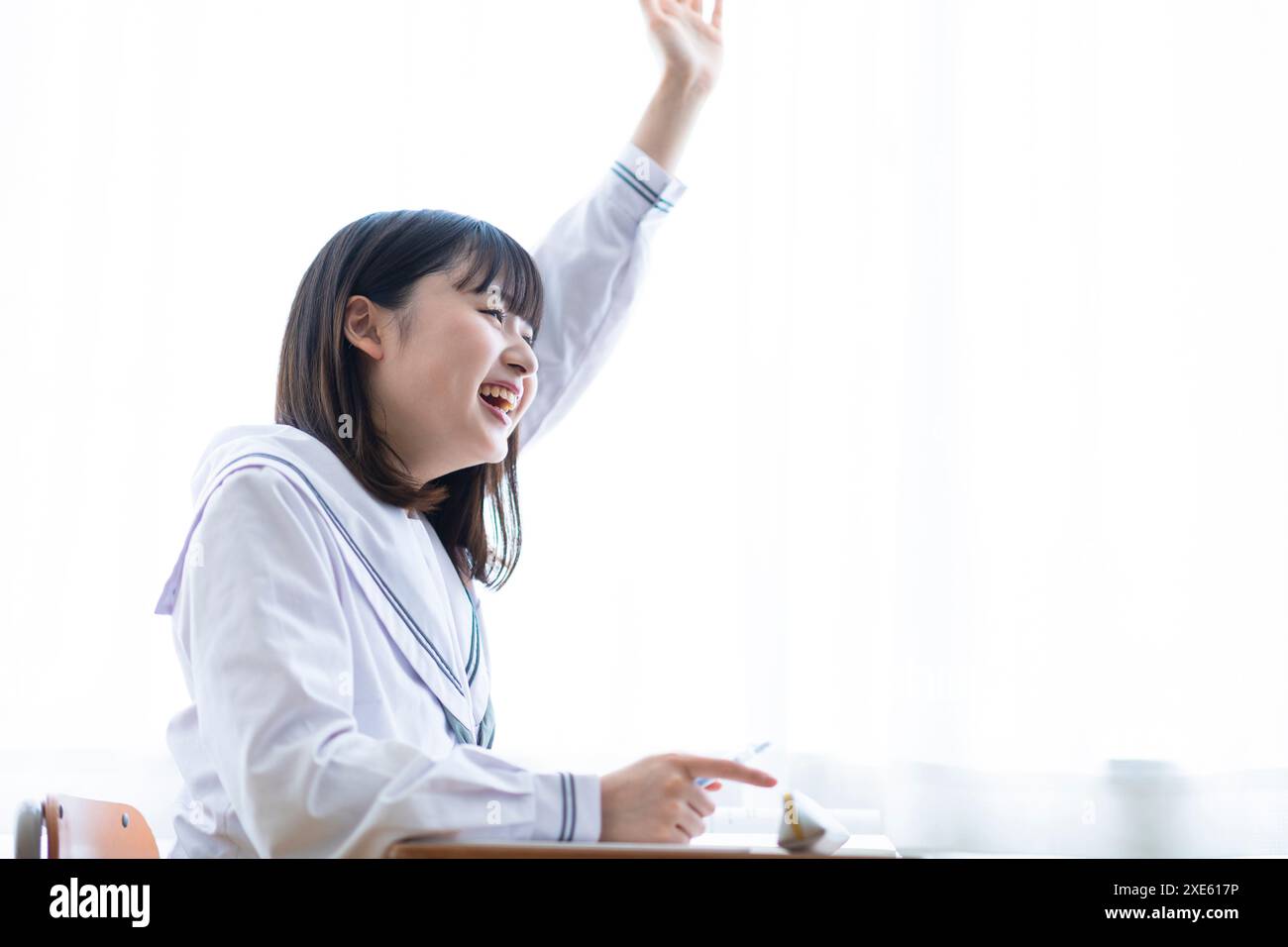 Portrait schoolgirl raising hand hi-res stock photography and images ...
