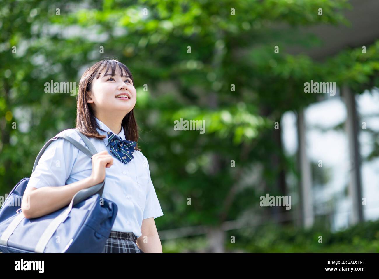 Girl walking in school uniform Stock Photo - Alamy