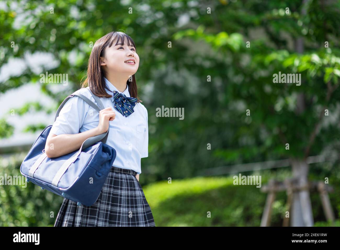 Girl walking in school uniform Stock Photo - Alamy