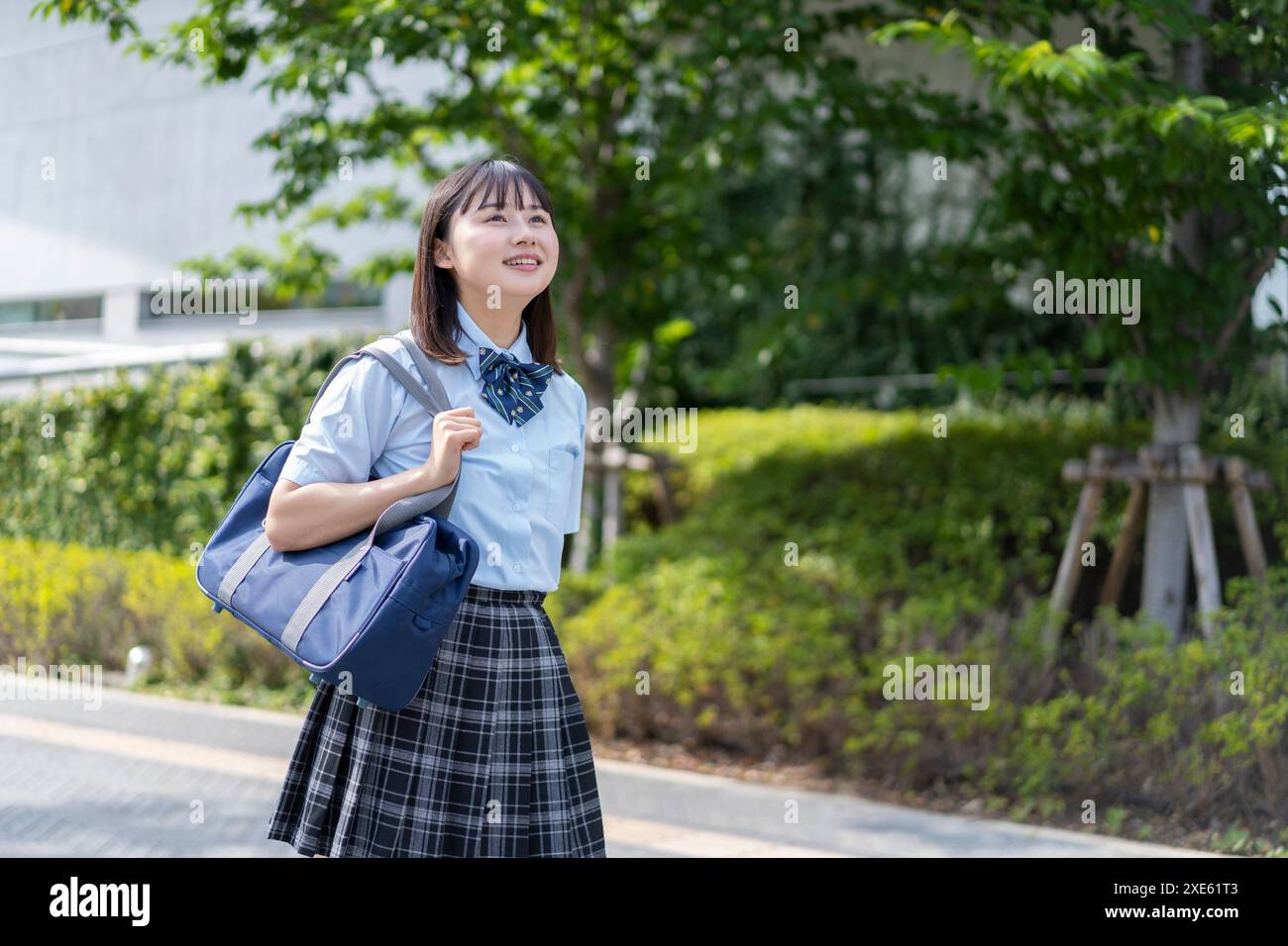 Girl walking in school uniform Stock Photo - Alamy