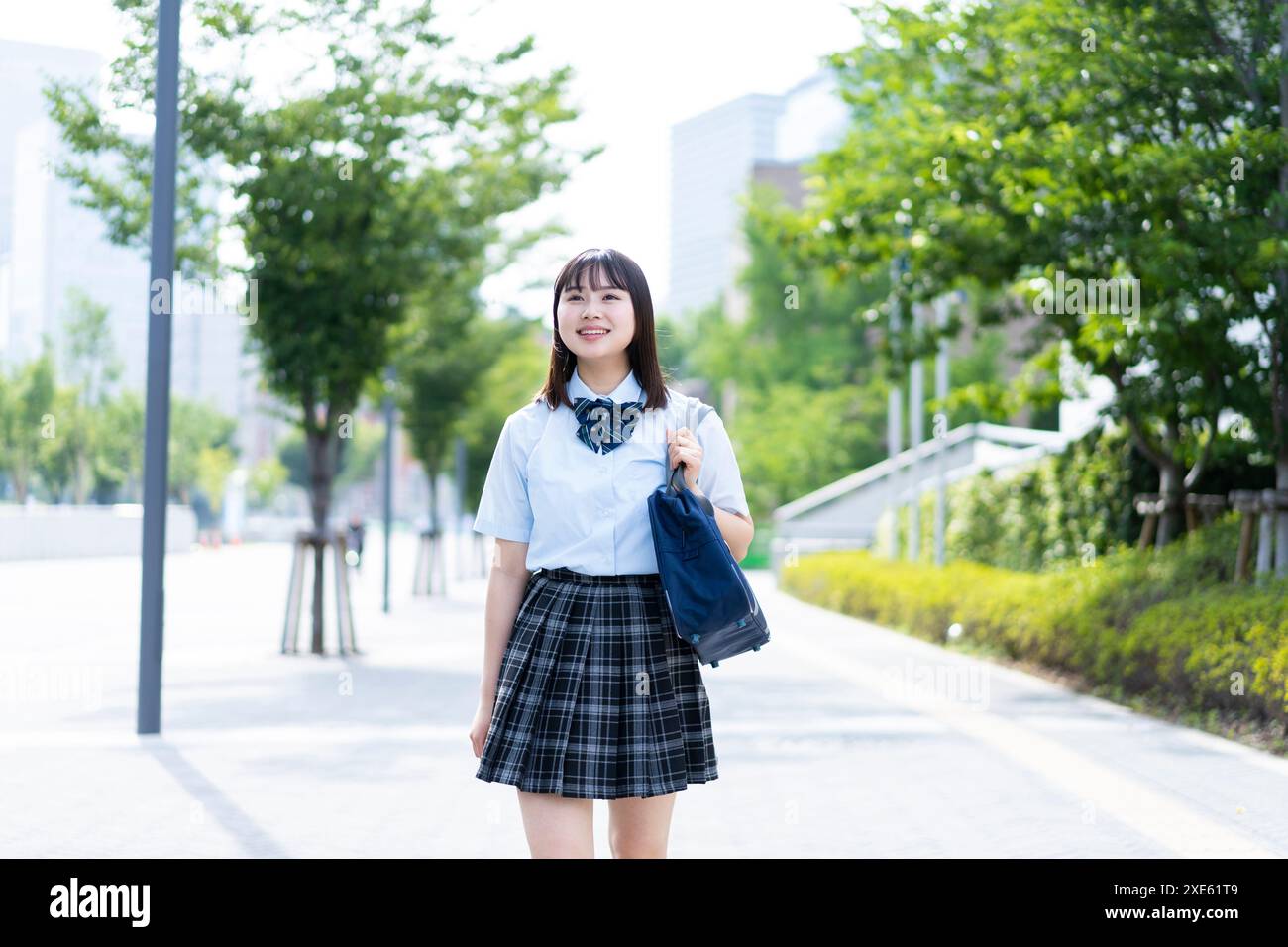 Girl walking in school uniform Stock Photo - Alamy
