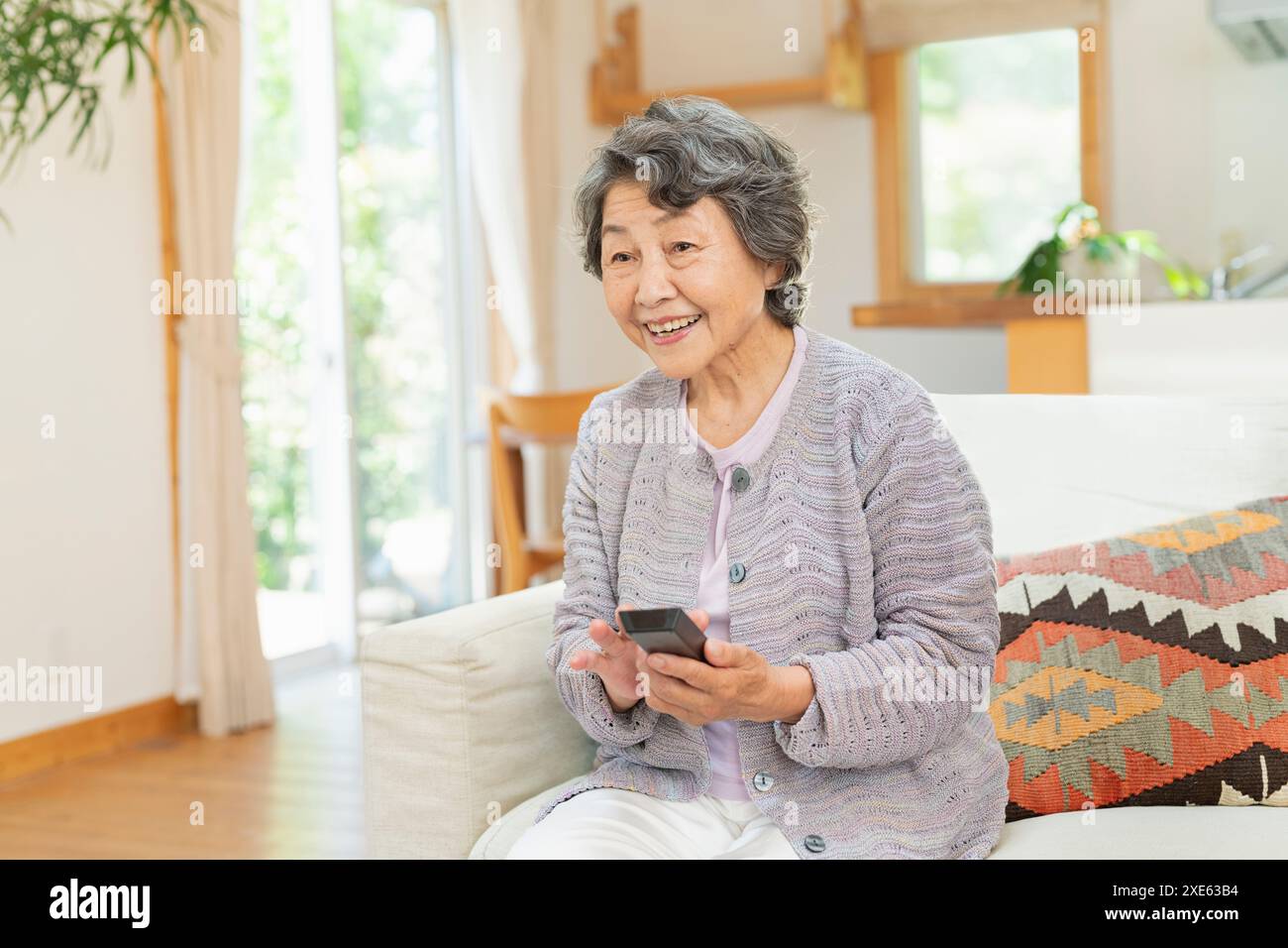 Senior woman watching TV at home Stock Photo - Alamy