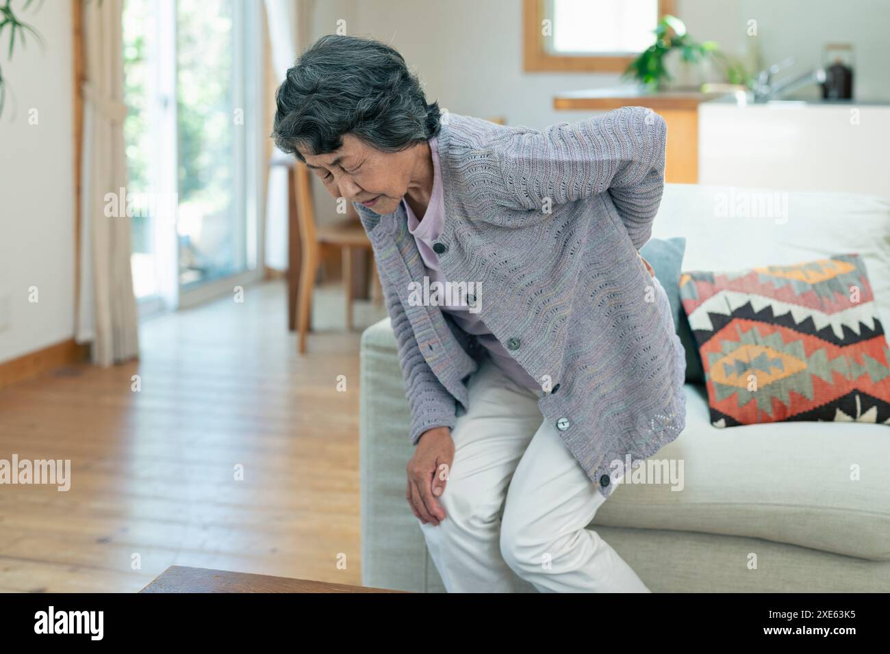 Senior woman suffering from back pain Stock Photo - Alamy
