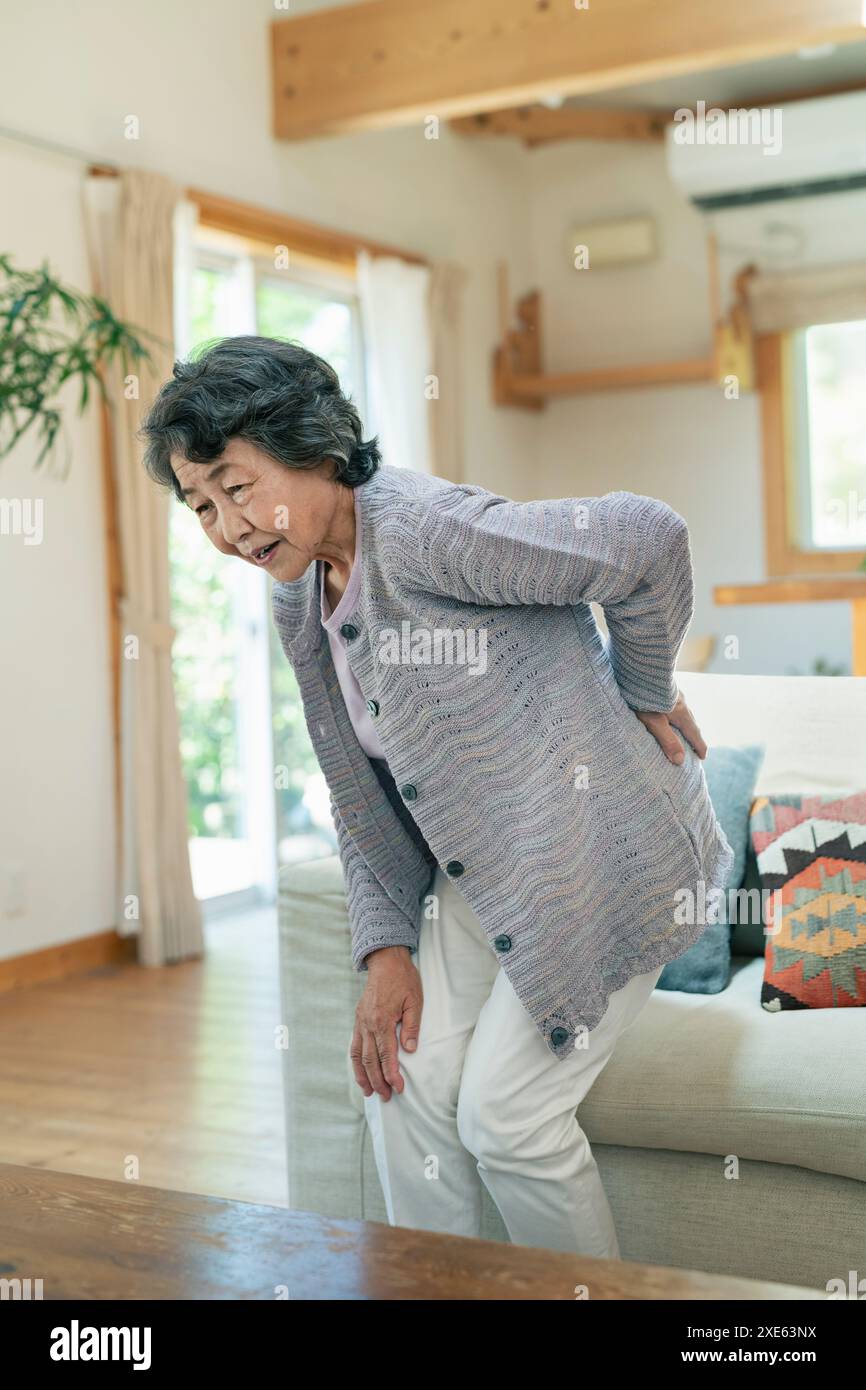 Senior woman suffering from back pain Stock Photo - Alamy