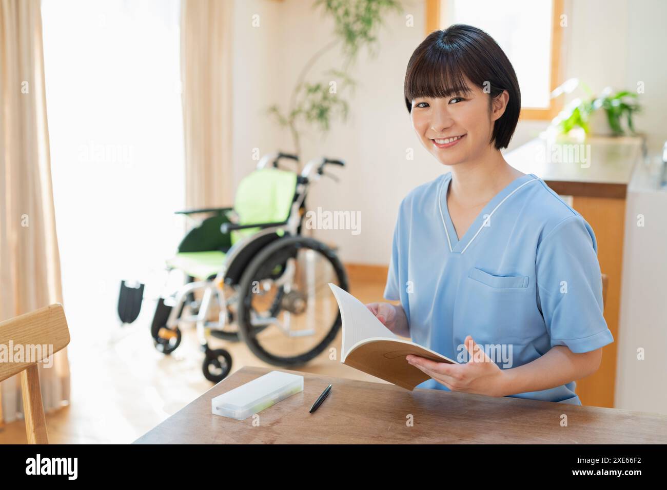 Female health care worker writing a diary Stock Photo - Alamy