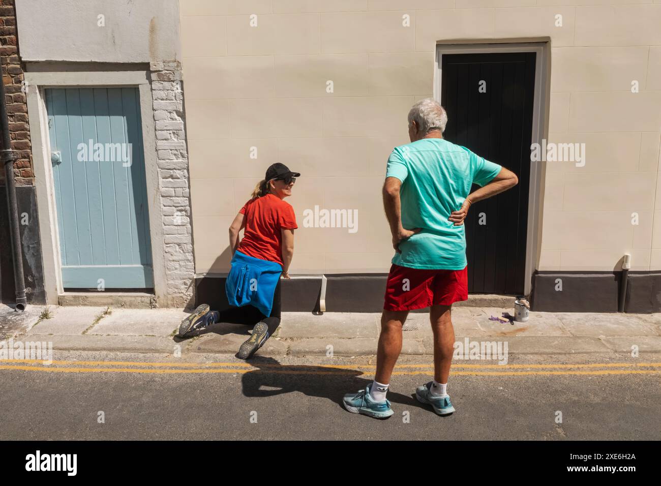 England, Kent, Deal, Man Talking to Woman doing DIY Stock Photo