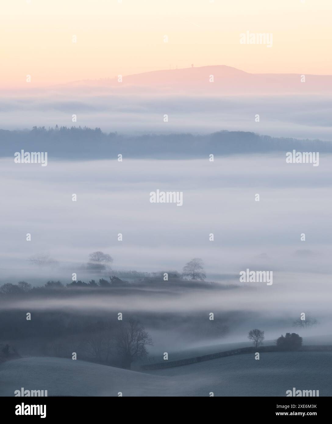 Dramatic and beautiful misty winter conditions viewed from the top of Ragleth Hill near Church Stretton, South Shropshire, England, UK Stock Photo