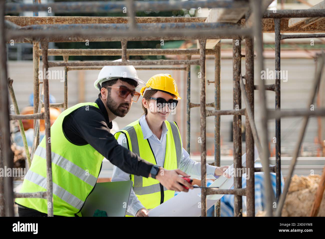 Engineer and architect working on the construction site, double ...