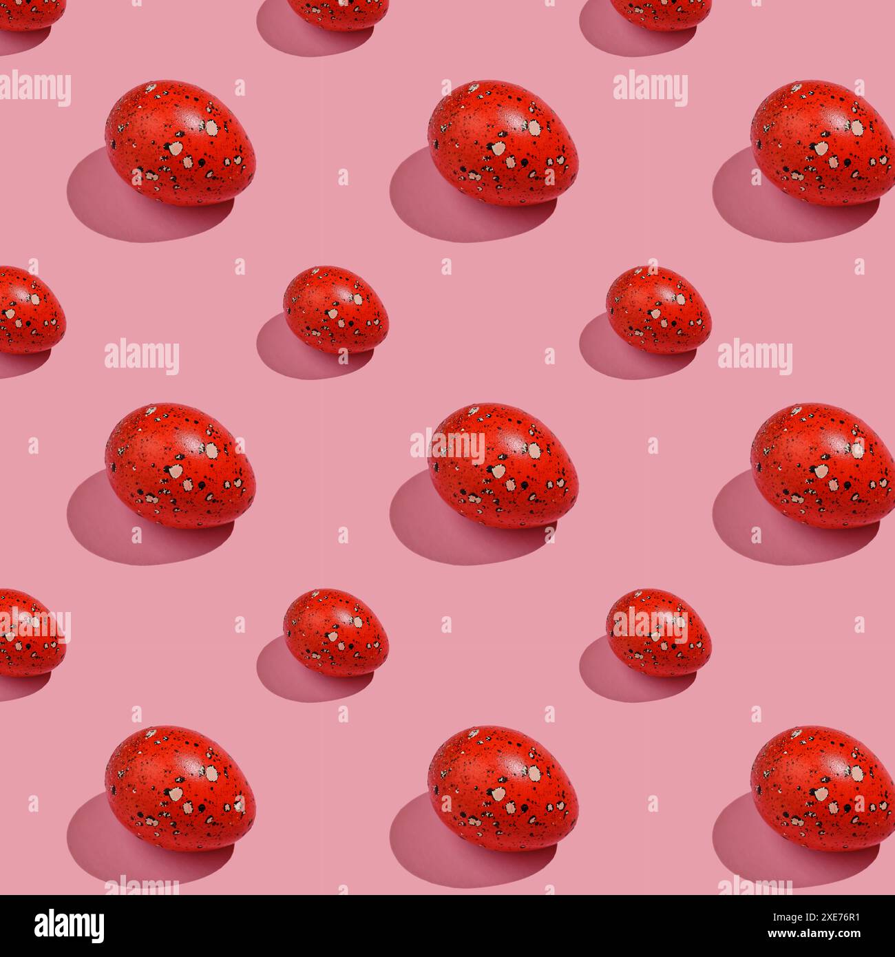Easter composition pattern in red shades. Painted eggs on a pink background. Stock Photo