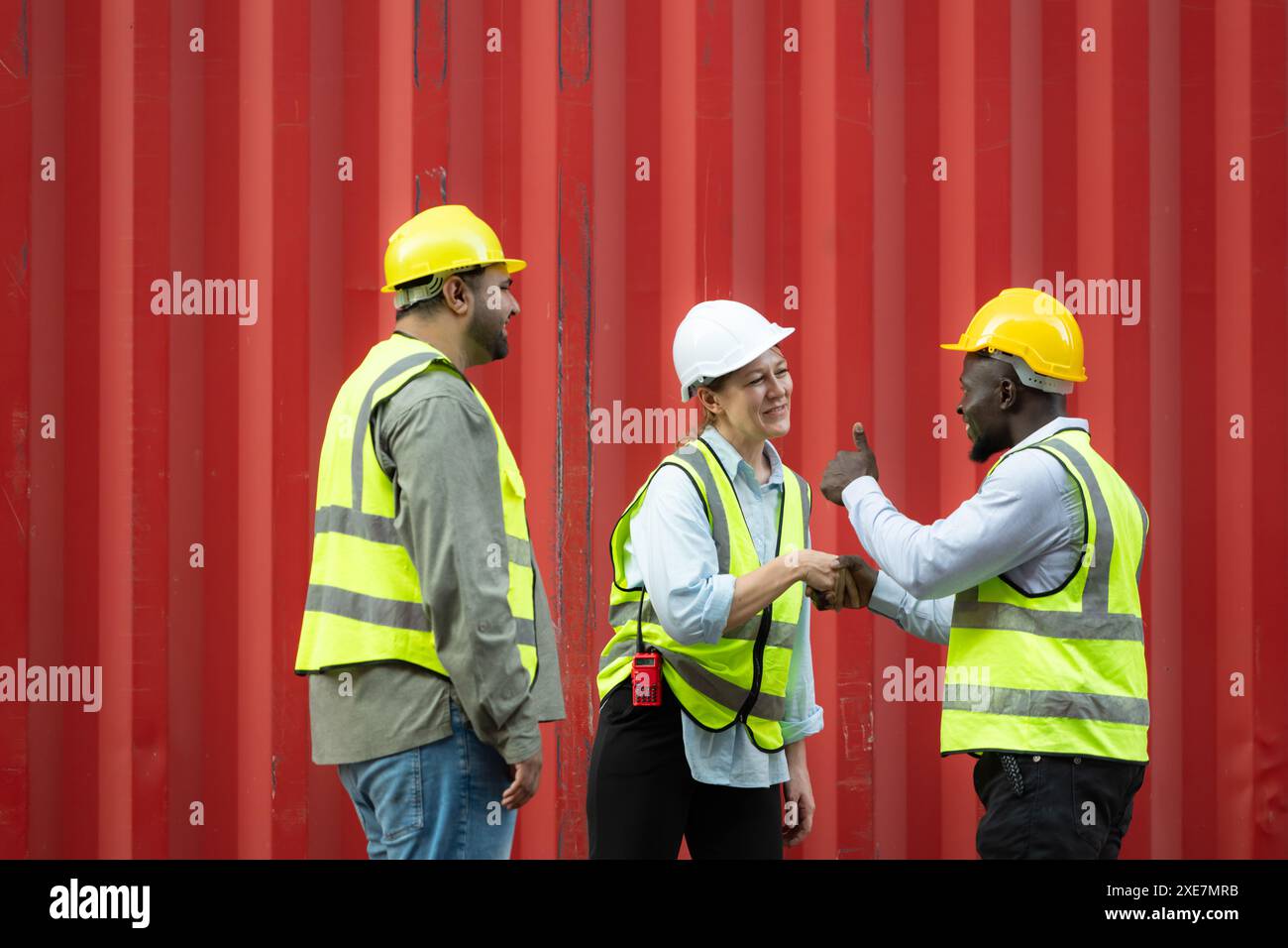 Group of workers in a container storage yard greeting each other during ...