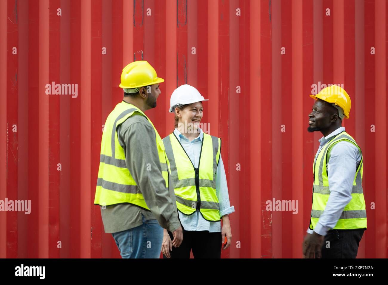 Group of workers in a container storage yard greeting each other during ...
