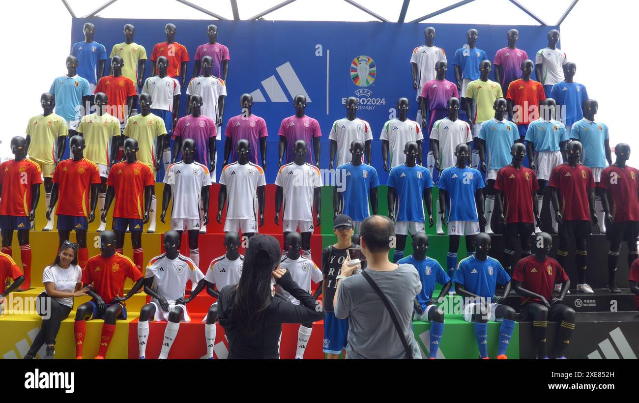 adidas Celebrates UEFA EURO 2024 in Limited time Pop up at K 11 Musea in Hong Kong China. Pedestrians take picture at the Spectacular Cheering Stand with the models in 50 adidas jerseys Stock Photo