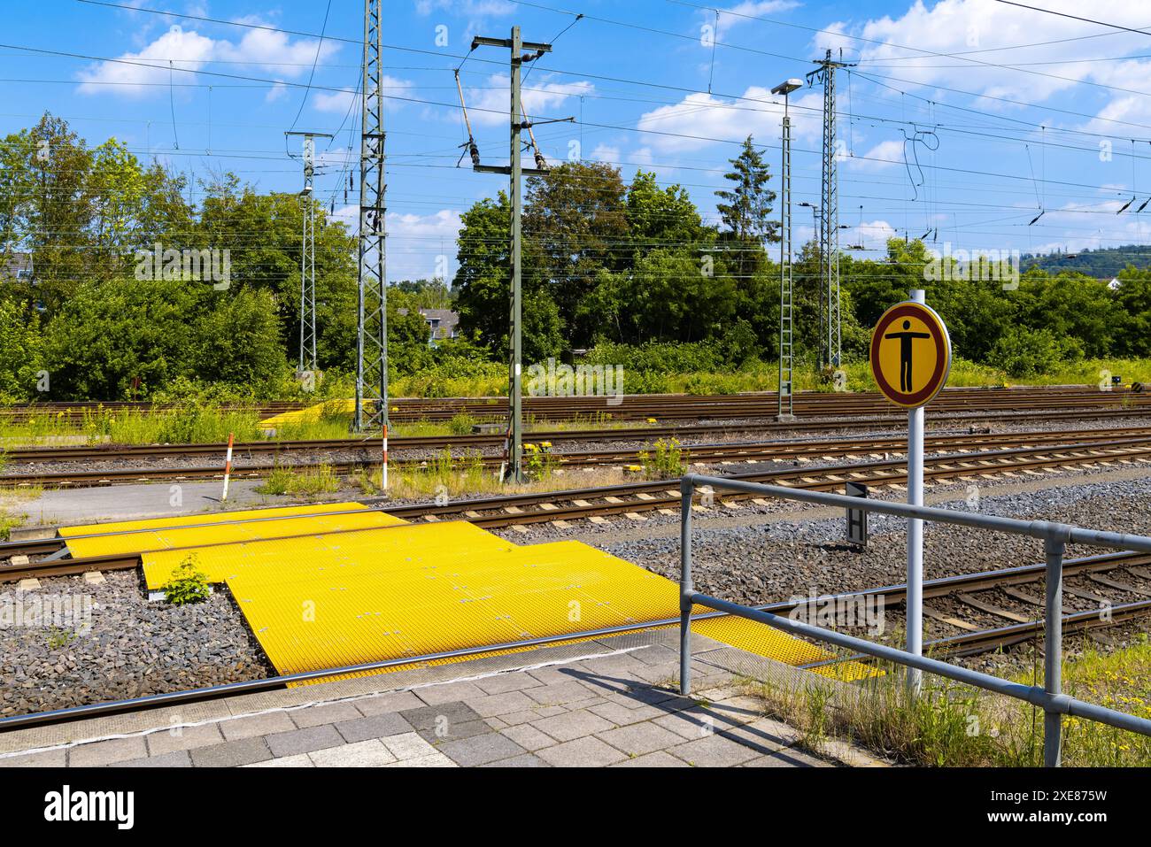 Pedestrian crossing over railway tracks painted in bright yellow ...