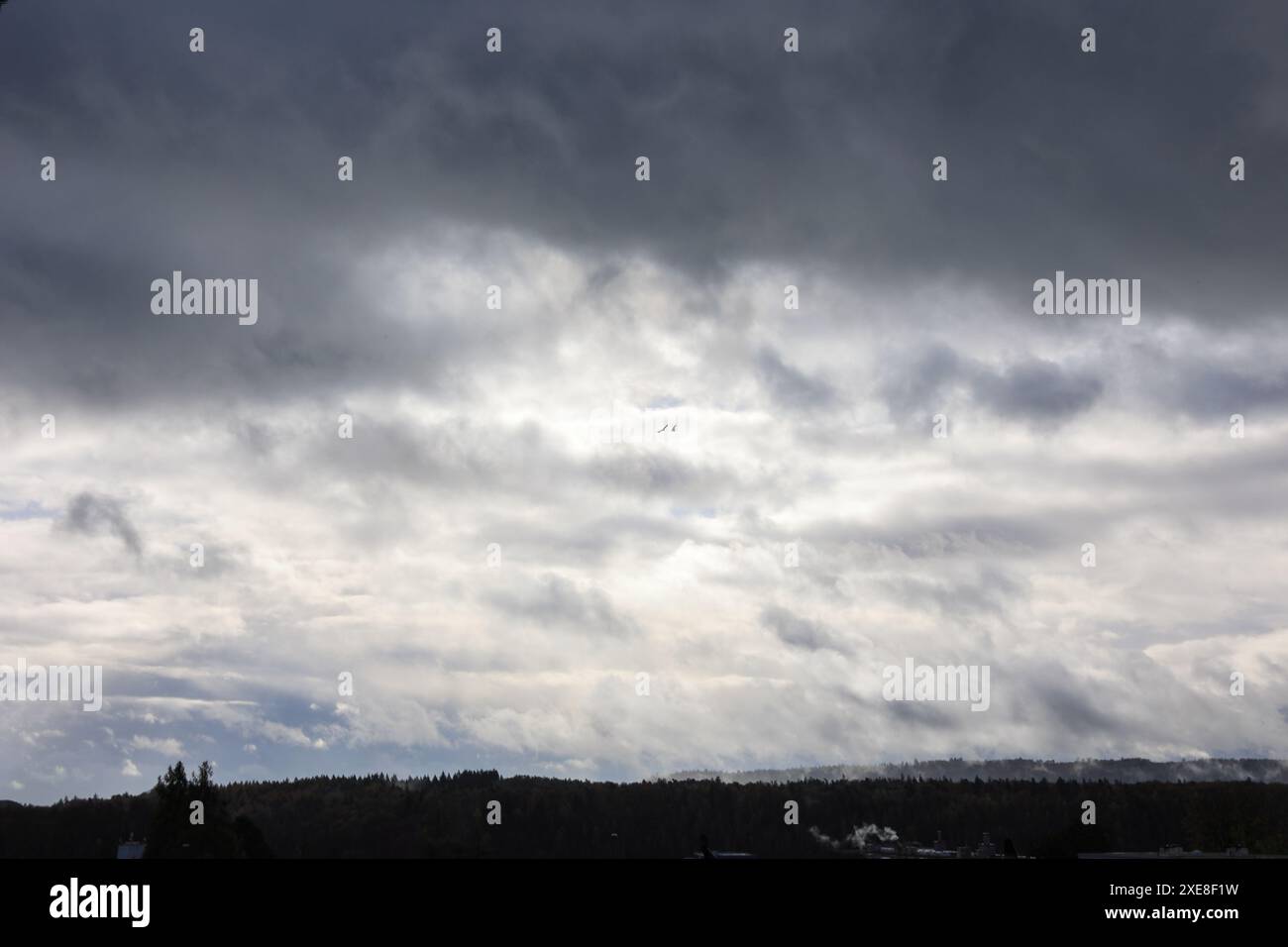 Dramatic sky after the storm with moving clouds and rising mist - texture, background Stock Photo